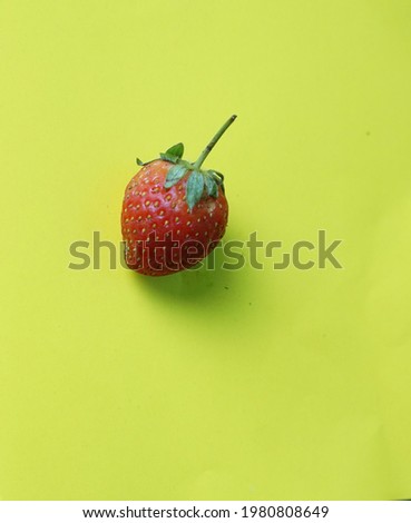 strawberry on yellow background - flatlay photography