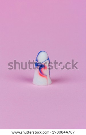 colorful foam earplug on pink background