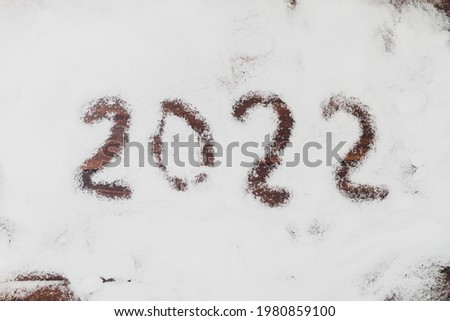 2022 greetings in the snow for Christmas in winter.