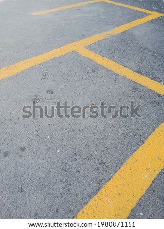 the parking lot is bordered with yellow paint stripes