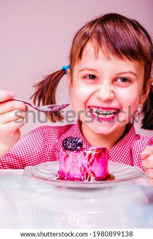 Portrait of cute attractive young girl with tasty cake. Holiday, sweets, pleasure, food and childhood concept. Vertical image.