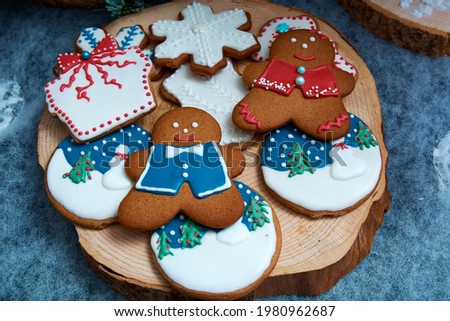 Christmas gingerbread on a wooden bar. Baking in the form of men, padaoks, stars and pictures