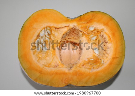 half orange pumpkin on white background