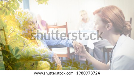 Composition of smiling senior caucasian woman in wheelchair and female doctor with tree overlay. retirement and senior lifestyle concept digitally generated image.