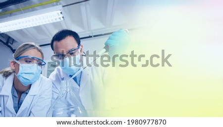 Composition of male and female lab technicians at work, with yellow blurred copy space to right. medical and science research concept digitally generated image.