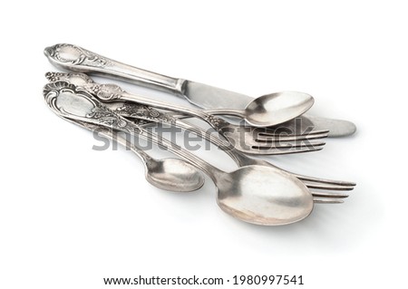Group of old silver cutlery isolated on white Royalty-Free Stock Photo #1980997541