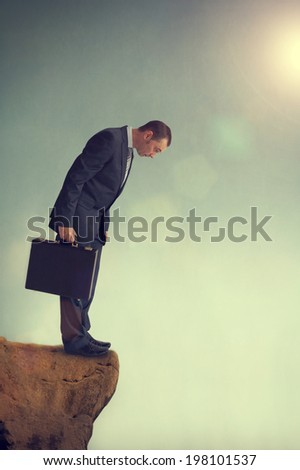 businessman facing a dilemma on a cliff edge Royalty-Free Stock Photo #198101537