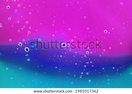 Liquid art gel background. Abstract textured neon background of slime. Macro photo of slime toy for kids.