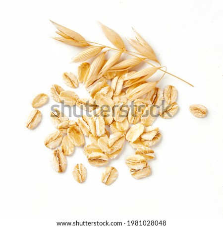 Oat flakes and ears of oat isolated on white background. Flakes for oatmeal and granola. Perfect image of oat flakes for you design. Royalty-Free Stock Photo #1981028048