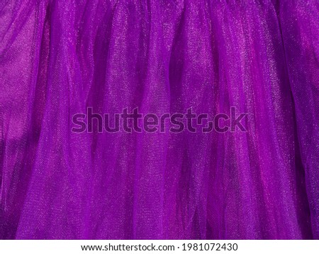 Purple tulle fabric texture top view. Violet background. Fashion trendy color feminine tutu skirt dress flat lay, female blog glossy backdrop text sign design. Girly abstract wallpaper,textile surface