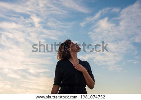 Portrait of woman looking up to the sky Royalty-Free Stock Photo #1981074752