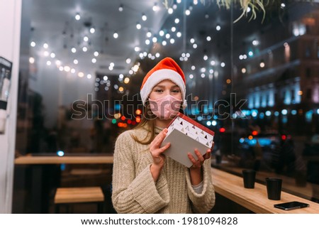 Portrait happy young beautiful woman, hold gift box and smile in cafe.