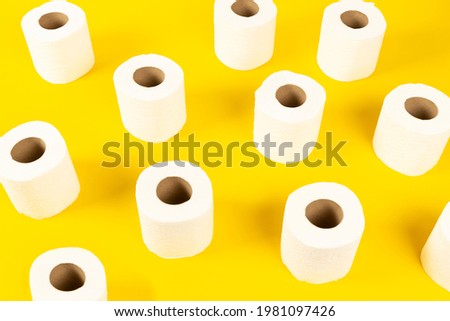 toilet paper in various shapes on yellow background
