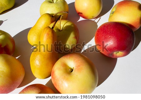 Close up ripe organic pears fruit with red apple on white background 