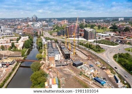 Aerial footage of construction work being done in the city of Leeds in the UK on a housing complex know as The Green by the Leeds and Liverpool canal Royalty-Free Stock Photo #1981101014