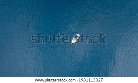 High Altitude Birds-Eye View of Fishing Boat with Diver Swimming in the Water