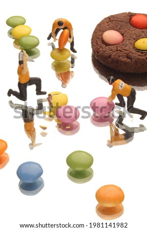 close-up studio colorful bonbon sugar cookies and miniature model concept