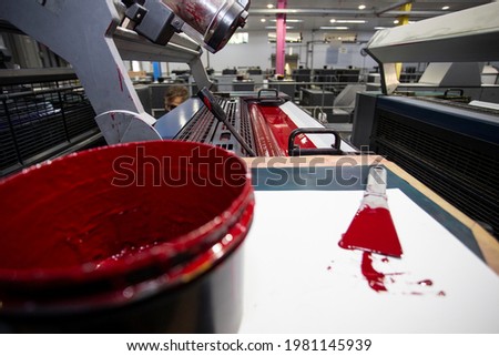 Spatula with red ink for industrial printers