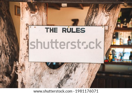A blank rules sign on tree