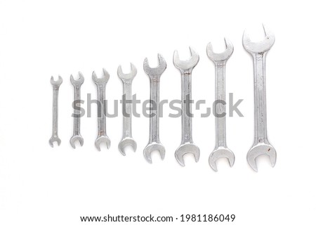 Set of wrenches different size on white background with copy space, text place. Banner with instruments kit for repair car. Business card for tools shop. Close up. Size line. Flat lay. Layout. Mockup.