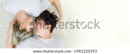 On top of Happy Asian homosexual men or gay couples are lying on the white wool carpet, Both of them are in the mood of love and attachment. Concept of LGBTQ pride. Royalty-Free Stock Photo #1981220393