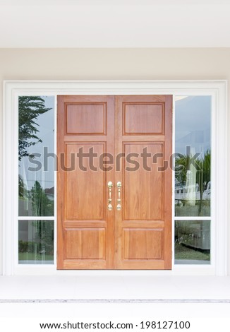 Double wooden doors with twin glass and frame
