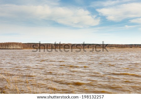 Lake landscape with waves on the background of sky