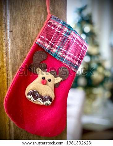 A plaid with reindeer - designed christmas stocking.
