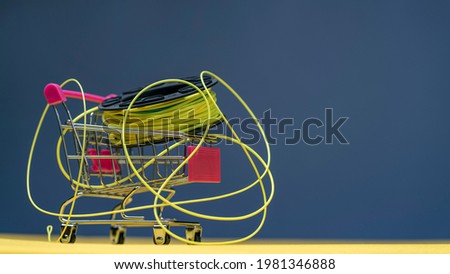 Fly fishing reel with a line in a mini trolley. Fly fishing shopping concept. Royalty-Free Stock Photo #1981346888