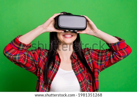 Photo of brunette funny young lady play wear 3d spectacles red shirt isolated on green color background