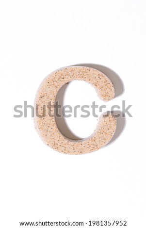 Letter C of the sand isolated in white. summer concept. alphabet.