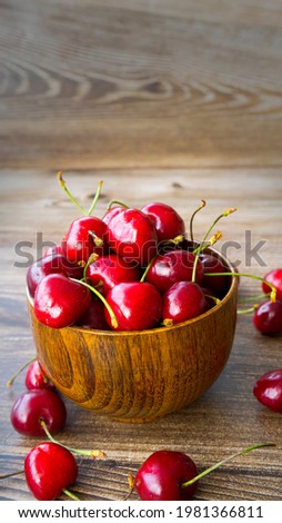 Wooden cup with ripe cherries