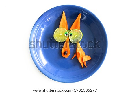 Food art creative concepts. Funny wolf made of fruits and vegetables, such as carrots and cucumber isolated on a white background.