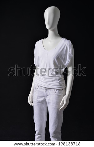 Mannequin female shirt and white trousers on black 