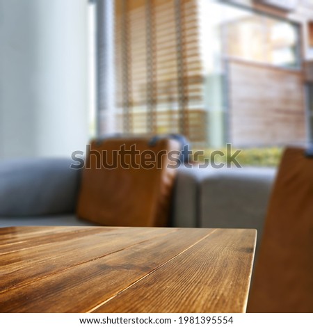 Wooden desk of free space and window background. 