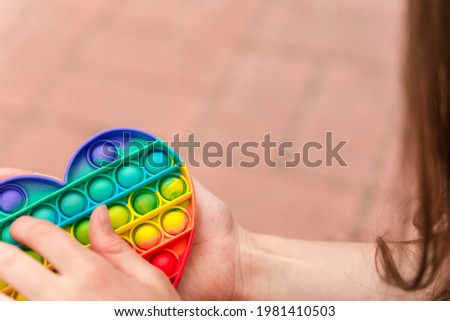Colorful antistress toy fidget push pop it in kid's hands