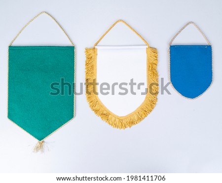 three different sizes and colors Empty blank Pennant fabric isolated on white background.