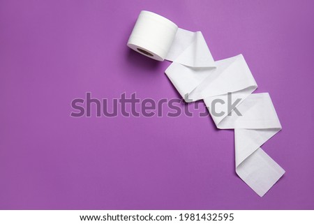 Roll of toilet paper on color background Royalty-Free Stock Photo #1981432595