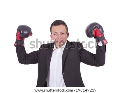 Portrait of a businessman with boxing gloves flexing biceps while standing against white background