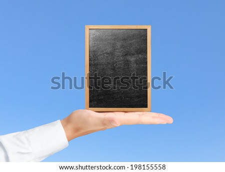 businessman holding a blank blackboard 
