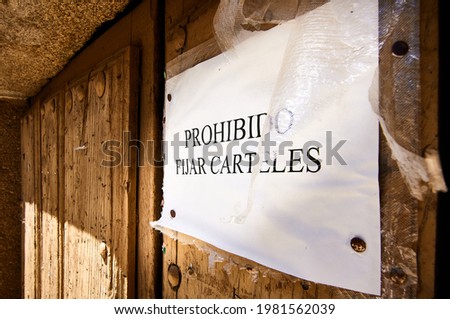 Close-Up Wooden Door With "No Posting" Sign Fastened With Pins