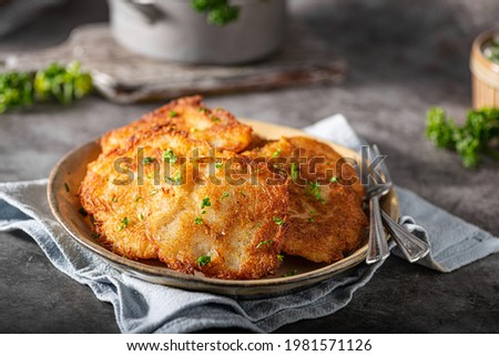 Homemade potato latkes with garlic sour creame and fresh herbs