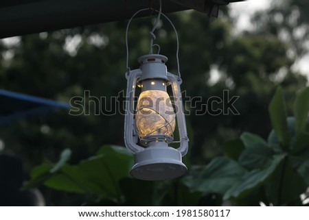 A hurricane lamp burning kerosene oil