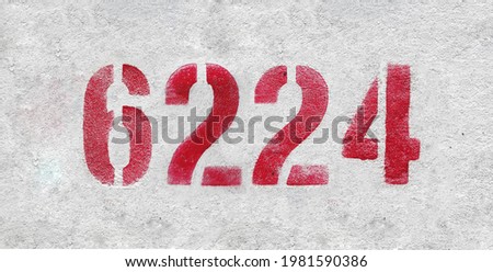 Red Number 6224 on the white wall. Spray paint.