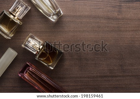 different perfume bottles on the wooden background Royalty-Free Stock Photo #198159461
