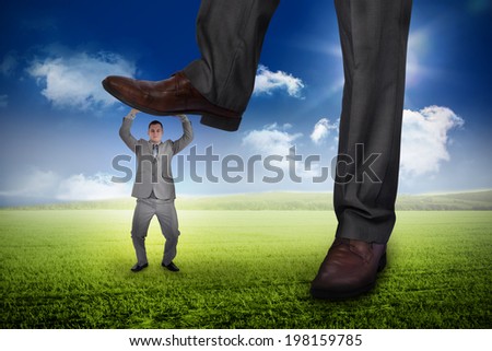 Composite image of businessman stepping on tiny businessman against sunny green landscape