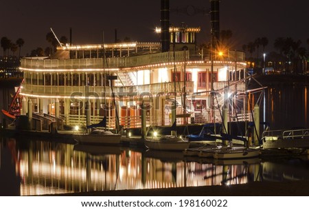Night view of an authentic,vintage,American riverboat with two chimneys resembling the steamboats used in 1800s in Mississippi river. A view of Mission Bay and pier,San Diego,southern California,USA. Royalty-Free Stock Photo #198160022