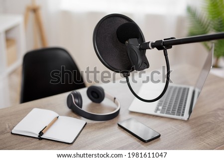 podcast, content making and blogging concept - workplace with computer, microphone and headphones for audio content making