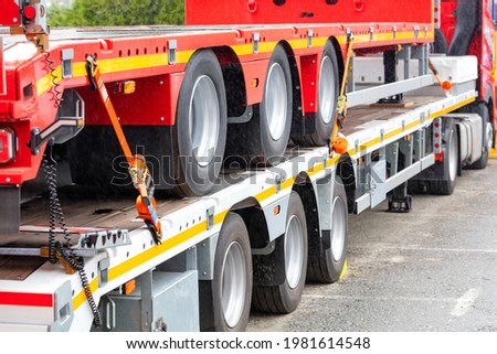 Truck vehicle platforms, heavy duty anchorage with ratchet fixing strap to connect the truck floor anchorage point. Selective focus, copy space. Royalty-Free Stock Photo #1981614548