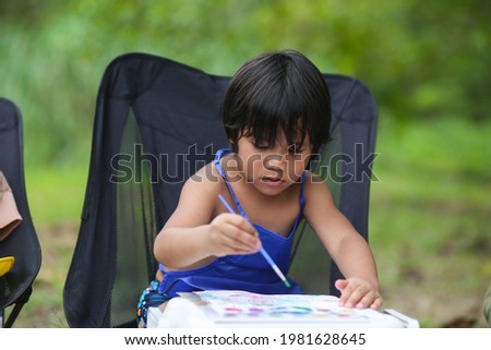 Asian little kid at the table draw with water color Learning and education of kid. selective focus